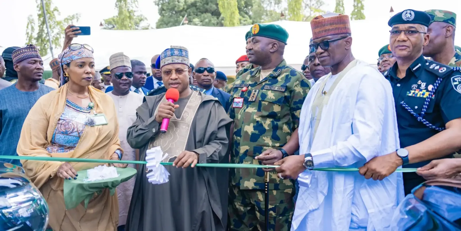 Public commissioning ceremony with a ribbon being cut